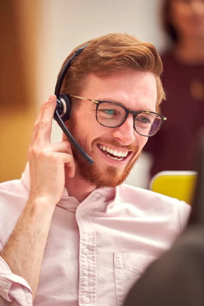 businessman wearing headset talking to caller in b 2